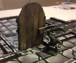 Dungeon tiles in use with a miniature of an orc